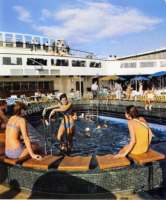 Passengers enjoying one of the two open-air swimming pools.  This is the Quarter Deck Lido