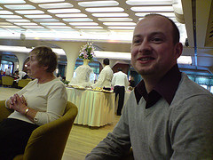 Me in Queens Room, with a vast plate of sandwiches, cakes and Scones in the background - all served by white-gloved waiters.