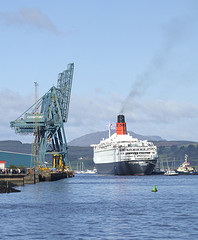 QE2 ties up at Greenock.  The cranes appear to salute the Queen.